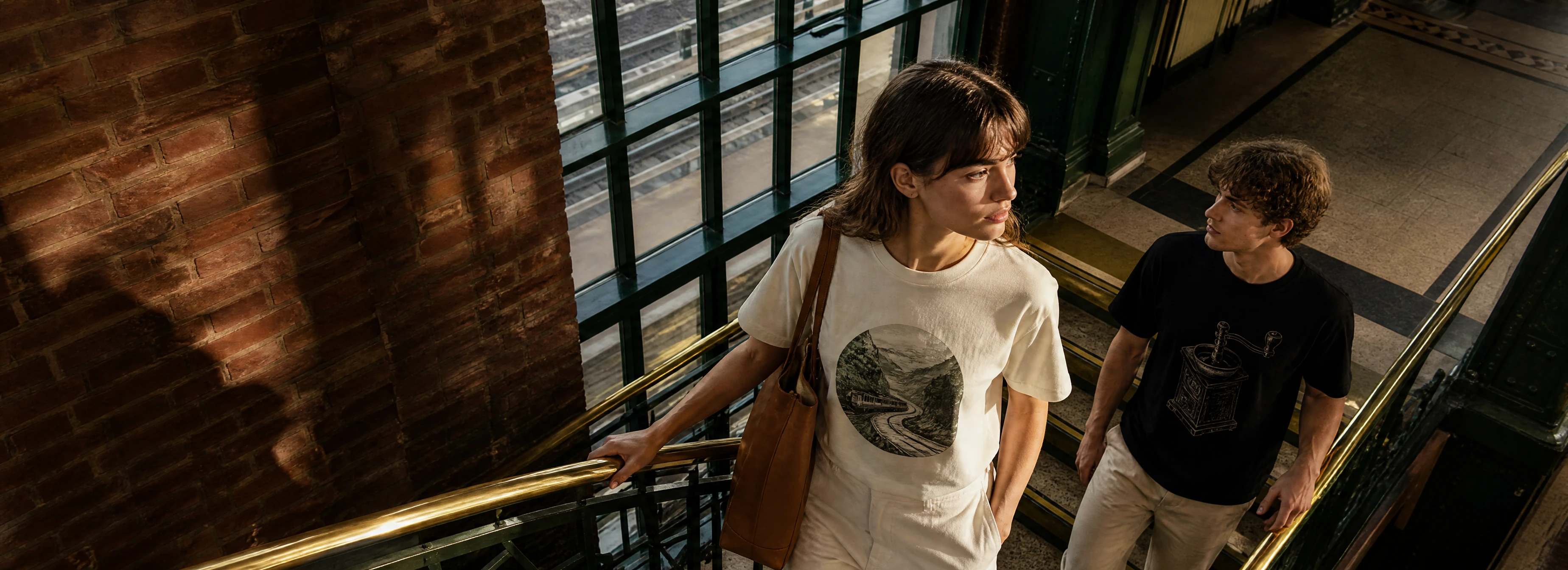 Two young adults wearing classic line-art T-shirts